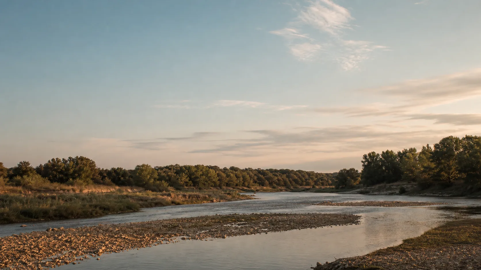 Wide quiet bend in a West Central Texas river in late summer