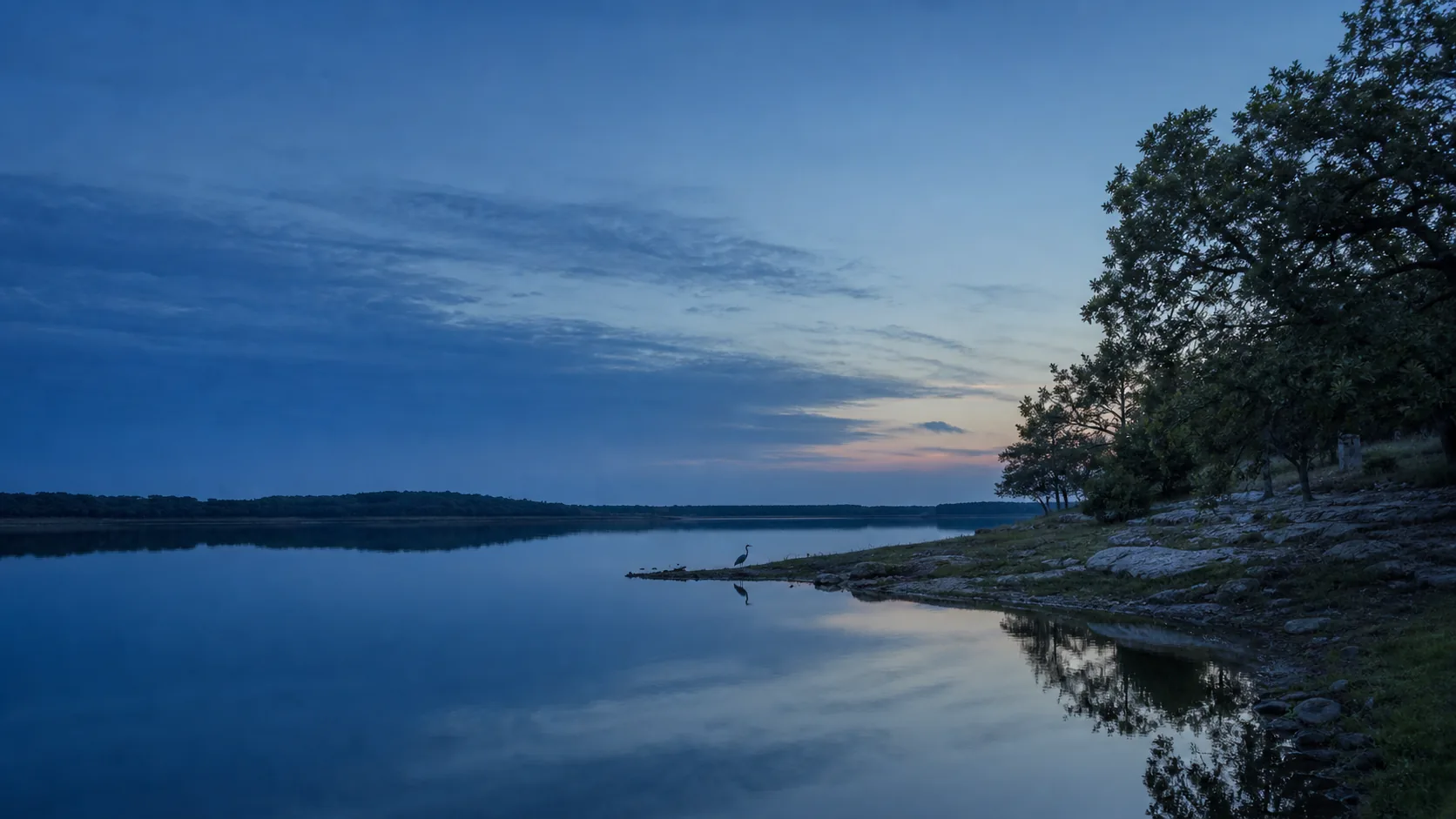Lake Cisco at blue hour, flat water reflecting deep cobalt sky